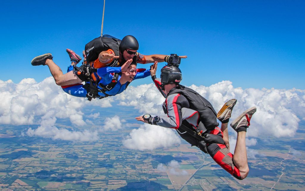 Tandem skydive with outside videographer. Photo by Thad Parker
