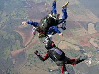 Houston mayor Annise Parker skydiving with instructor Hank Prewitt and Helaine Rumaner